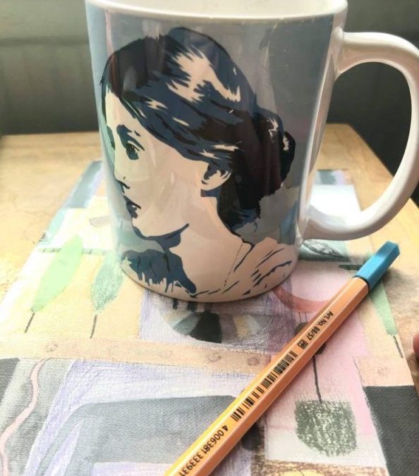 mug and notebook for writing prompts
